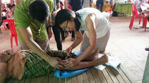 Doctor helping to perform basic medical procedures in underprivileged Cambodian communities