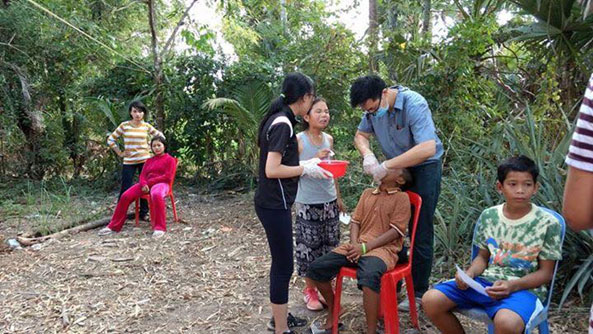 Dentists helping to clean teeth in a rural town in Cambodia